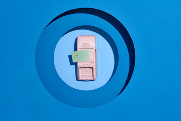 Pay by payment terminal on blue background