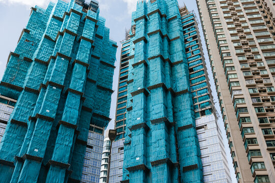 buildings are shrouded in scaffolding netting
