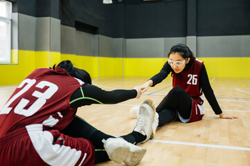 Basketball team preparing and stretching in school gym