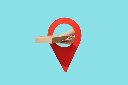 Hand holding a delivery box and location pin