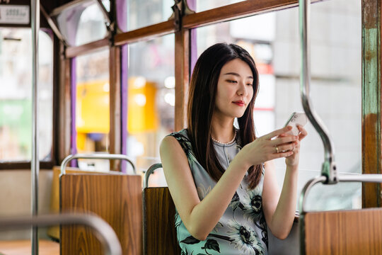 A woman sitting in a Ding Ding tram