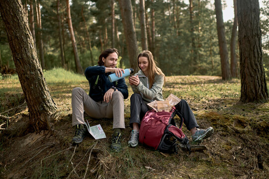 young tourists drink coffee on a break
