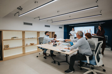 Fototapeta premium A diverse group of business professionals attending a dynamic business lecture, collaborating, and discussing statistics for profit growth and strategic planning.