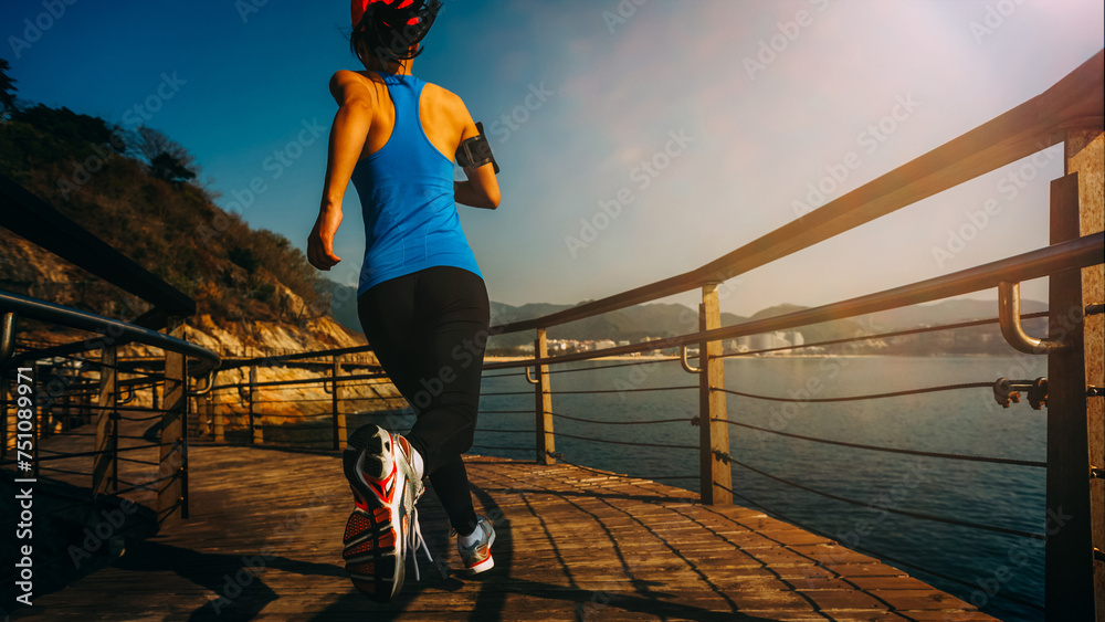 Poster Healthy lifestyle sports woman running on wooden boardwalk seaside