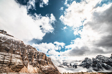 Mountain ranges against a cloudy sky.