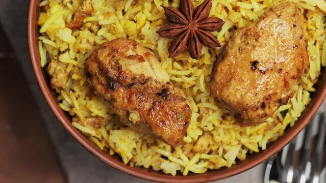 Chicken Biryani with Spices and Lemon in Clay Bowl, Popular Indian and Pakistani Food, Tilt Up Camera Movement