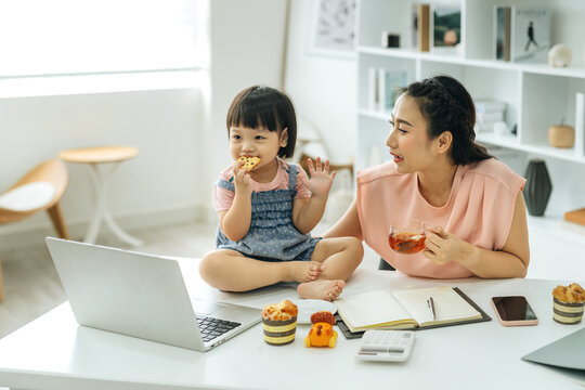 Mother working from home with kids.