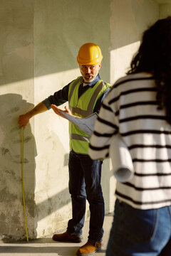Architect Discuss Wall Measurements Client Construction Site