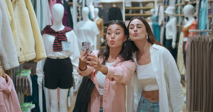 Friends clothing store taking selfies laughing in close-up Women's happiness shopping capturing moments. Women's happiness joy fashionable finds blissful experiences Women's happiness each smile.