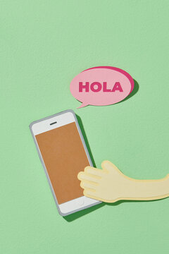 hand holding mobile smart phone with hola text