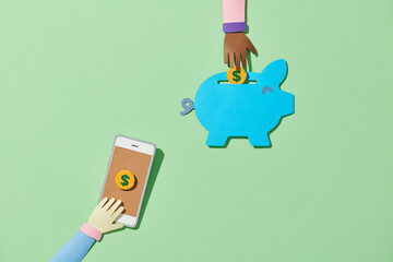 Smartphone sending money into a piggy bank on the green background