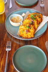 A plate of fried food with a dipping sauce on a table