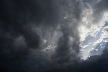 Obraz premium Dramatic dark storm thundercloud rain clouds on black sky background. Dark thunderstorm clouds rainny landscape. Meteorology danger windstorm disaster climate. Dark cloudscape storm disaster gray sky