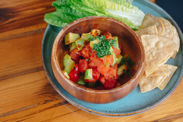 A bowl of food with a green leaf on top