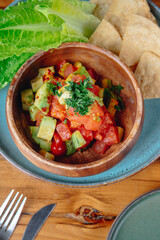 A bowl of food with a green leaf on top
