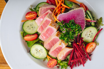 A plate of food with a variety of vegetables and meat