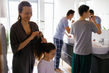 Family washing morning routine shared bathroom