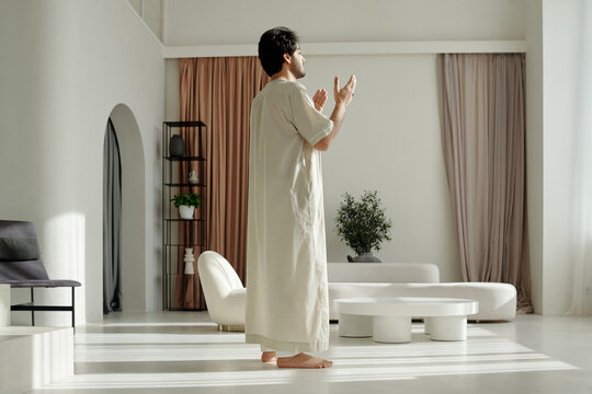 Fototapeta Middle Eastern Man Praying In Living Room