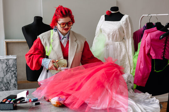 Woman creative designer dressmaker making wedding dress
