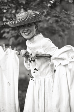 village woman hangs clothes in nature