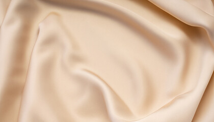 Fototapeta premium Soft smooth beige silk fabric background. Fabric texture. folded and colorful, copy space