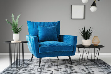 Stylish living room decor with a bold blue armchair and sleek coffee tables, against a subtle grey background, Generative AI