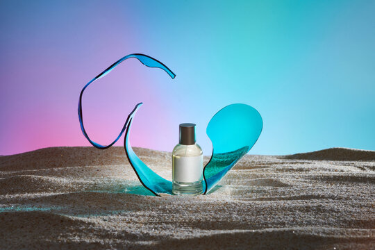 perfume bottles on the beach with crumpled sheet of acrylic 