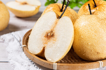 fresh Asian pear fruit and half sliced on wooden table.
