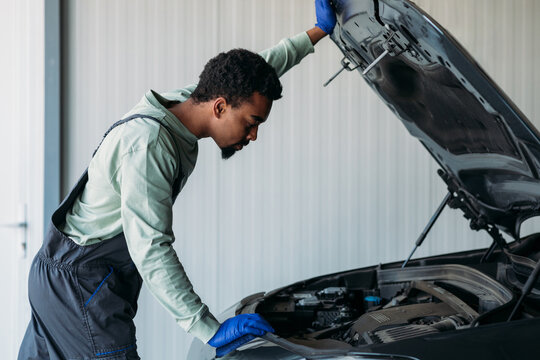 Mechanic Repairing Car in Garage