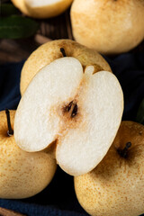 fresh Asian pear fruit and half sliced on wooden table.