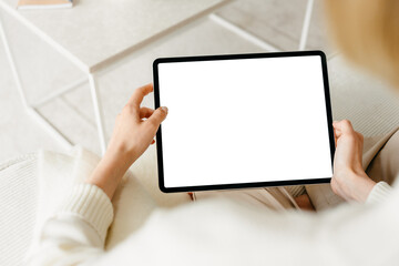 A tablet with a white screen in women's hands