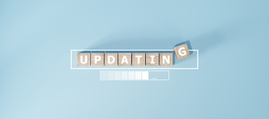 Wooden block with the word UPDATING in the loading progress bar Business concept.