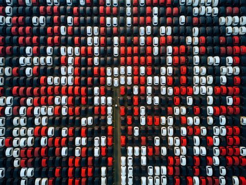 Full car outdoor parking in selective focus. Tight colored car rows on parking area vertical upper view. Generative AI.