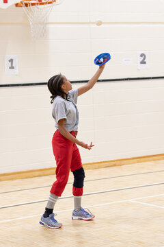 Child practicing softball catching using a Velcro pad and ball
