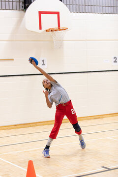 Child practicing softball catching using a Velcro pad and ball