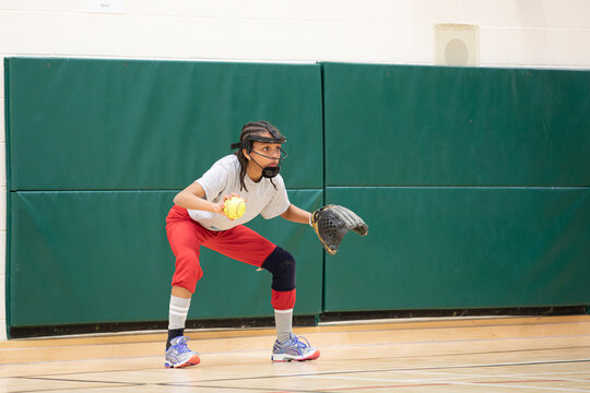 Child practicing proper ready position technique for softball
