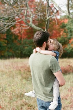 father hugging his toddler daughter