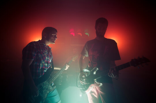 Music band playing at misty dark stage