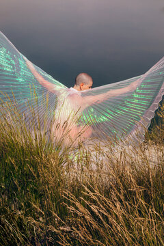Woman in nature with coloured wings