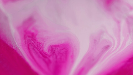 Ink drop. Fluid spill. Defocused pink white color pigment liquid paint drip stains spreading motion...