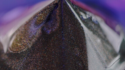 Glitter pyramid. Paint spill. Defocused neon blue purple bronze color glowing shimmering particles...