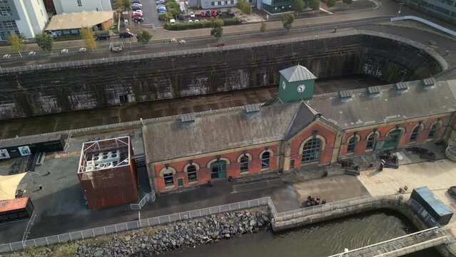 Aerial shot of Titanic Dry Docks, starting low and raising to the sky. 60fps and 4K resolution.