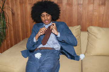 Businessman with afro hair on sofa, straight flash