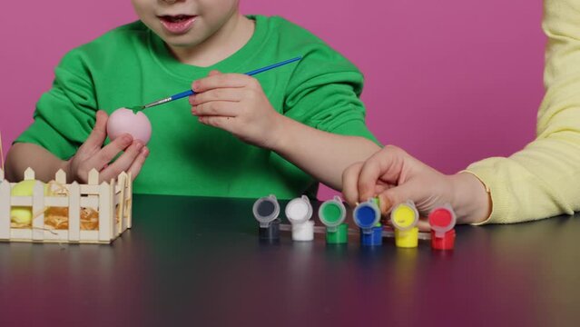 Young Adorable Kids Coloring Easter Eggs With Watercolor Paint, Creating Lovely Designs To Celebrate Spring Holiday. Cheerful Brother And Sister Painting Festive Decorations In Studio. Camera A.