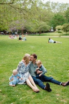 Mother, father and sons having fun in a park