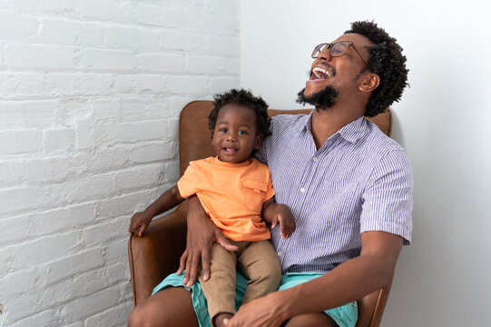 Dad laughing with his happy son