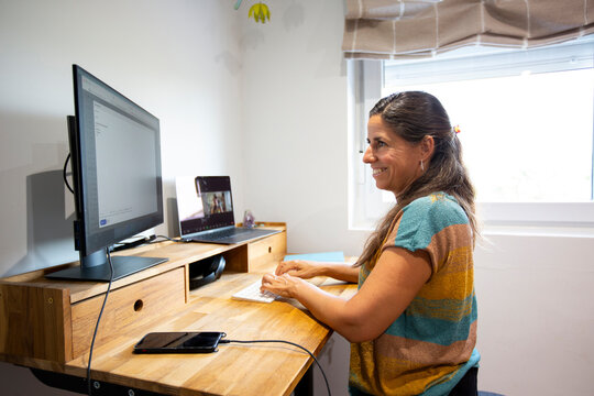 Smiling Woman working in standing desk in home office