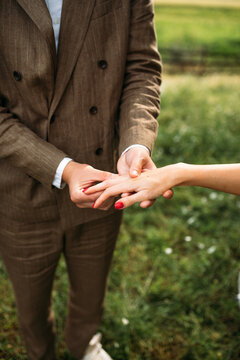 Man Putting Wedding Ring on Woman 