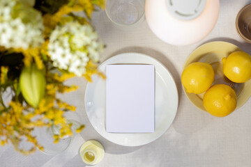 White paper mockup  card on summer dinner table.