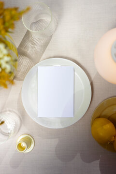 White paper mockup card on summer picnic table.